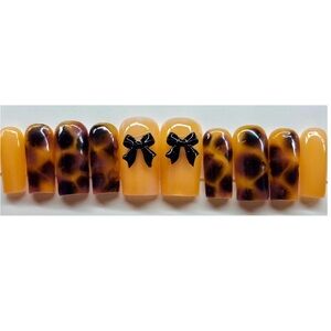 Tortoise Shell Patterned False Nails with Black Bow Accents